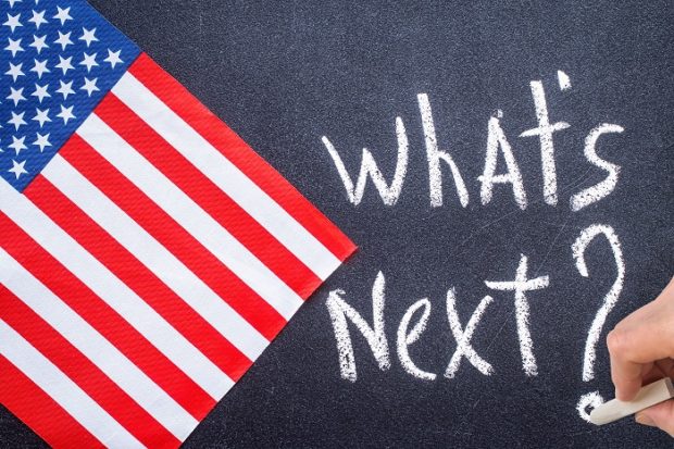 What's next on the chalk board and US flag. Election concept